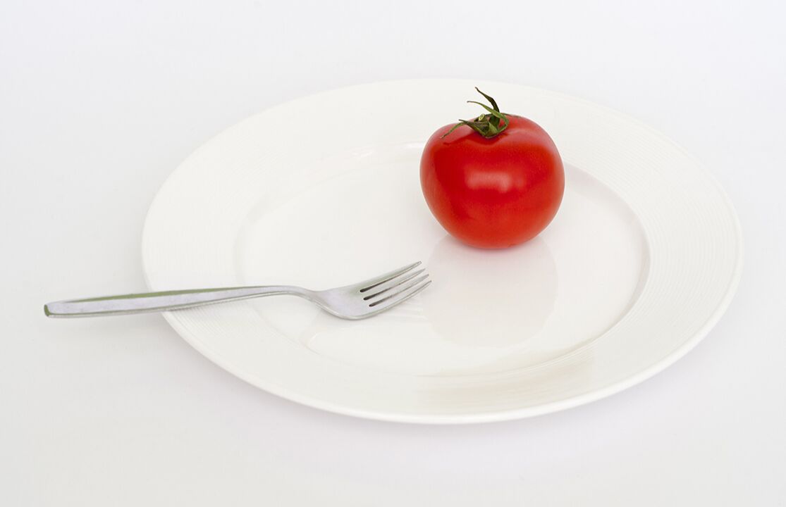 tomato with fork on the plate